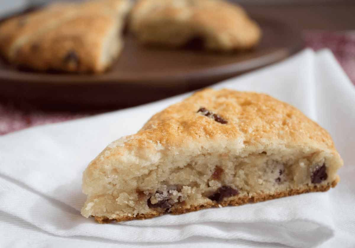 a cranberry scone on a white cloth napkin