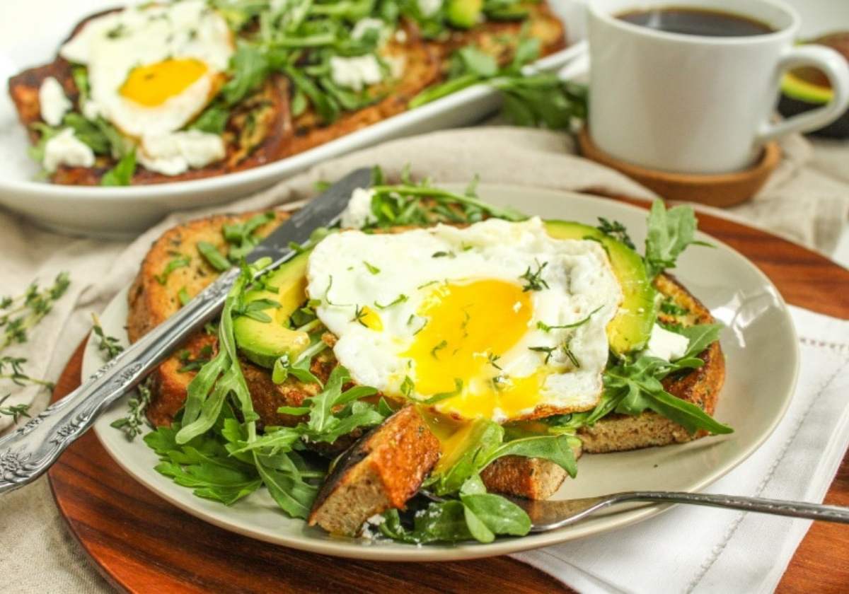 avocado herb french toast on a plate with arugula