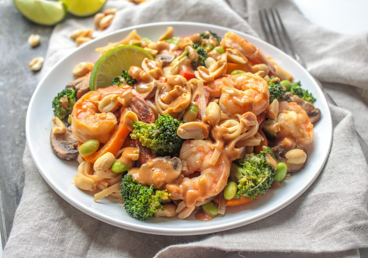 peanut sauce stir fry with shrimp on a white plate