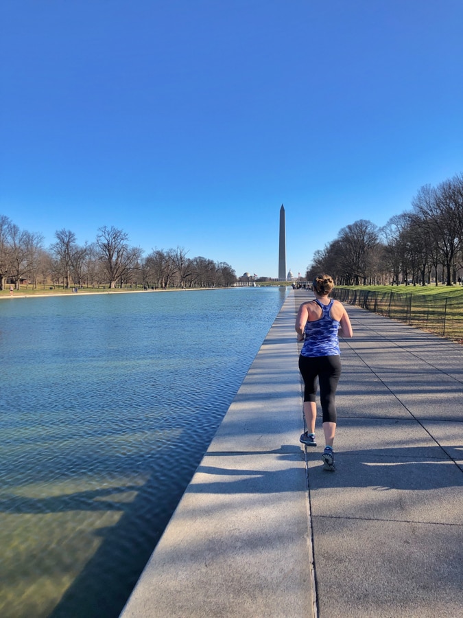 running along the reflecting pool towards the washington monument