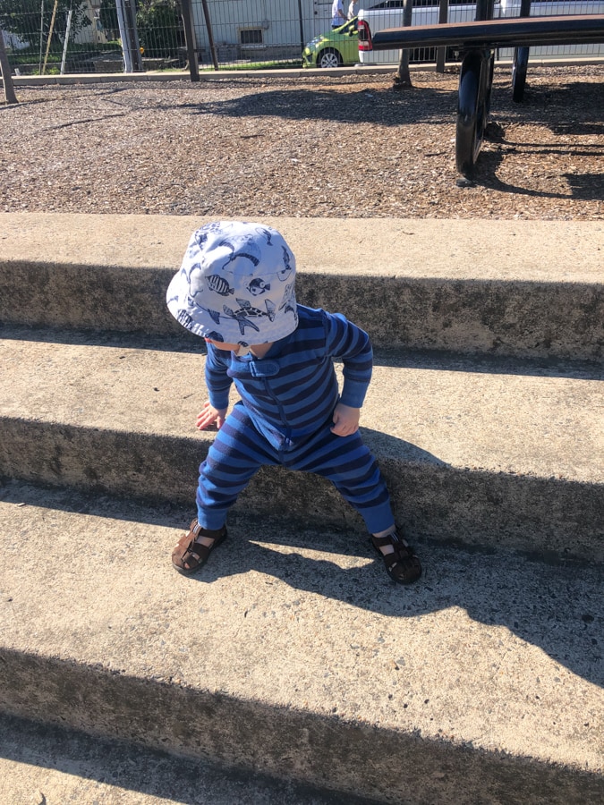 14 month old sitting on stairs outside