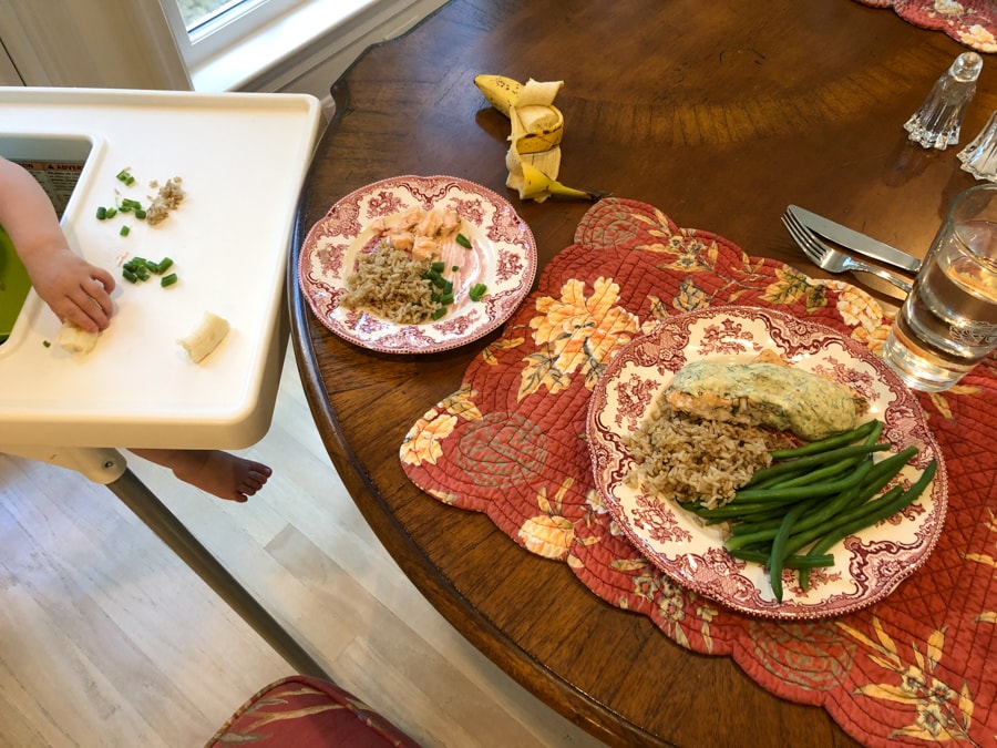 salmon, green beans, and rice on a plate plus baby hands eating