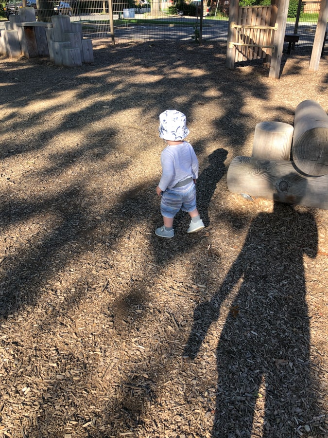 toddler walking on mulch 