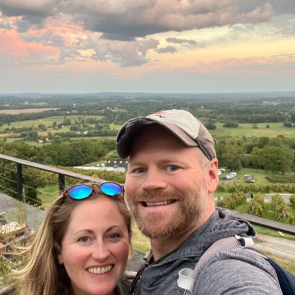 anne and matt mauney with a sunset view