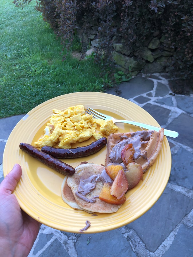 sourdough pancakes, peaches, sprouted almond butter, sausage, and eggs