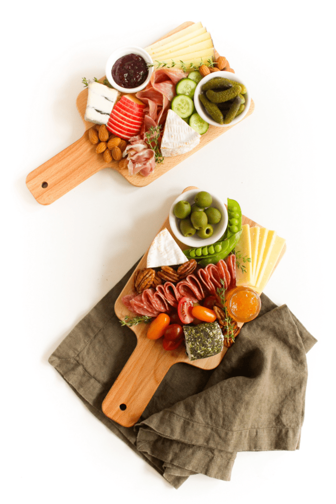 garnished charcuterie board with fresh herbs