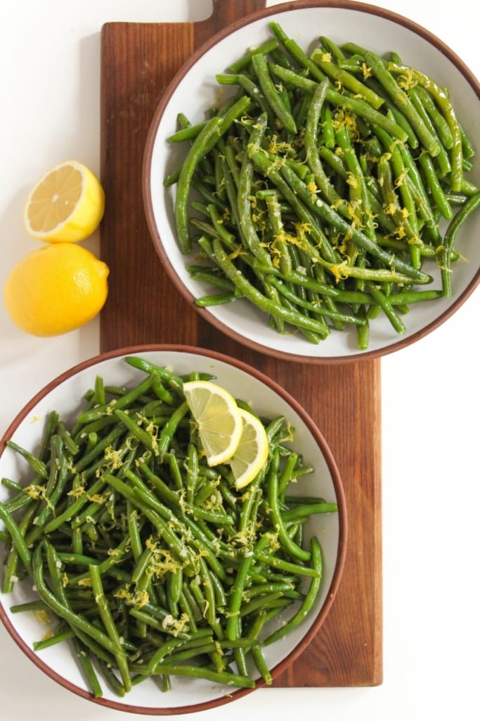 frozen green beans in 2 bowls with lemon zest