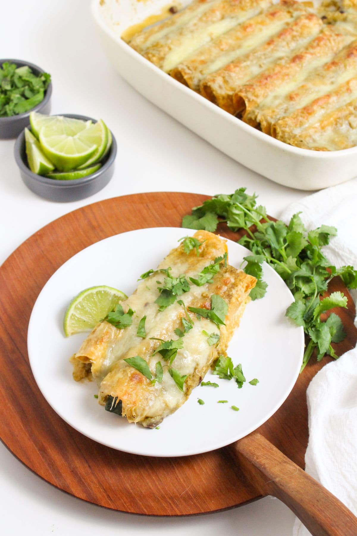 crock pot chicken enchiladas verde on a plate with cilantro