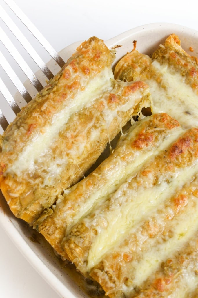cheesy chicken enchiladas verde in a baking dish