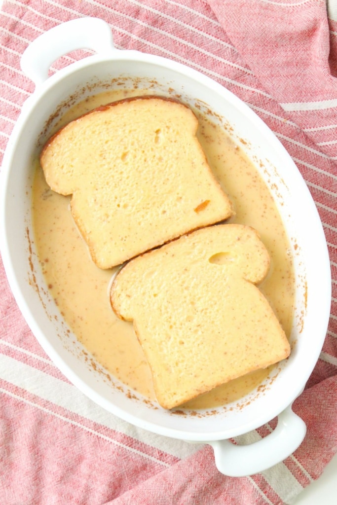 bread slices dredged in egg mixture in a shallow dish