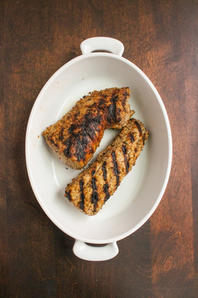 grilled pork tenderloin in a white dish