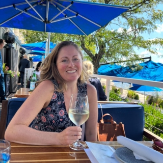 anne mauney holding a glass of prosecco