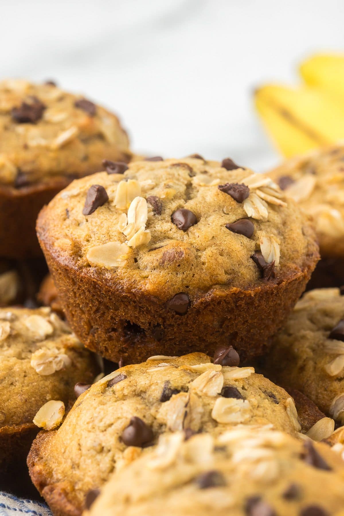 close up of a banana chocolate chip muffin with oats on top