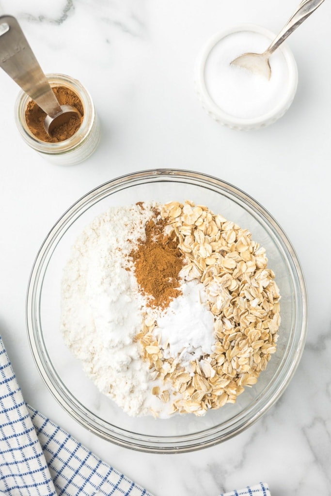 oats, gluten free flour, cinnamon, and baking powder in a large glass bowl