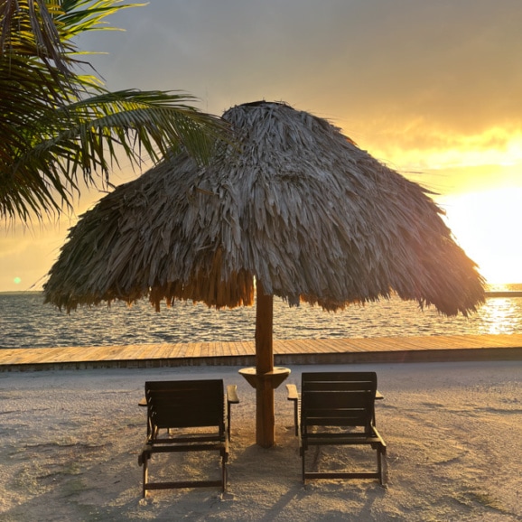 chairs under a cabana at turneffe island resort in belize