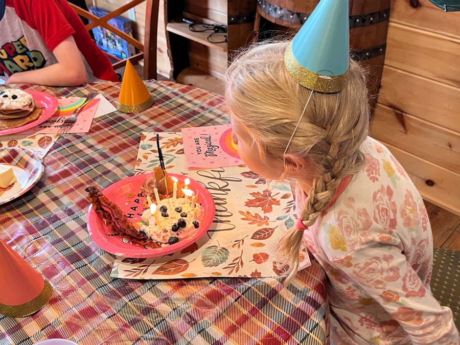 girl blowing out candles