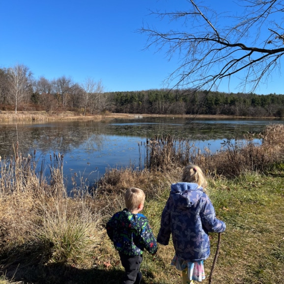 kids holding hands while hiking