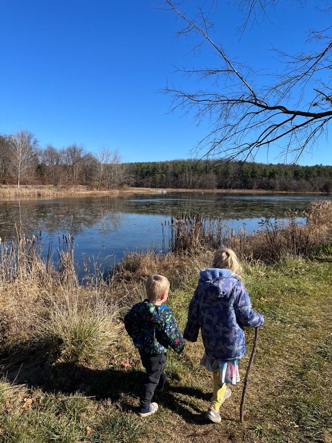 kids holding hands while hiking
