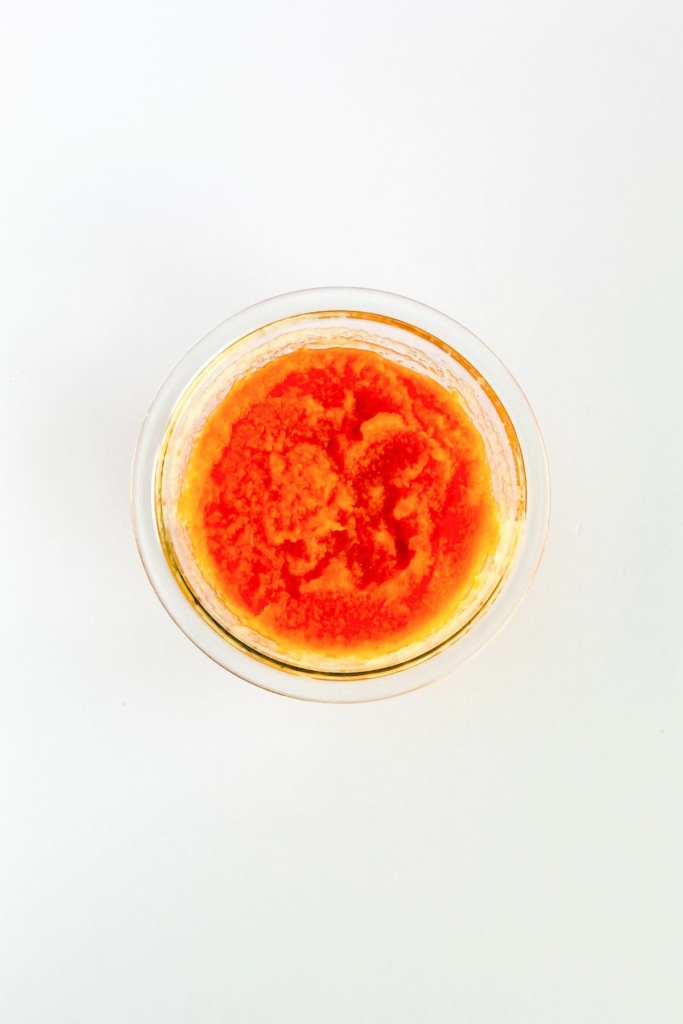 grated carrots and applesauce in a glass bowl