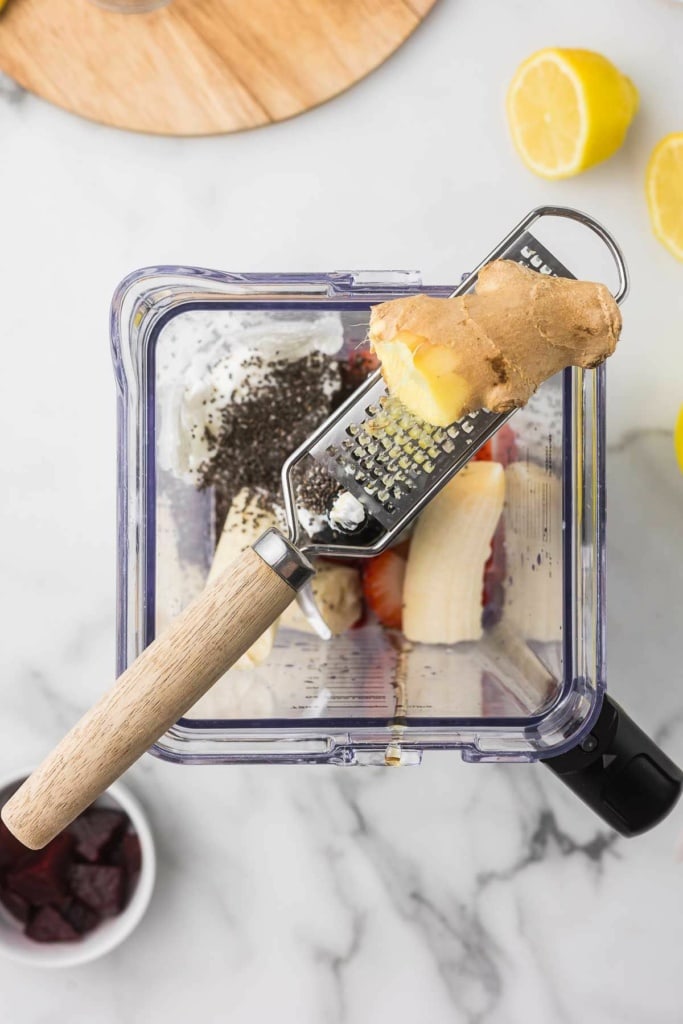 fresh ginger on a handheld metal grater