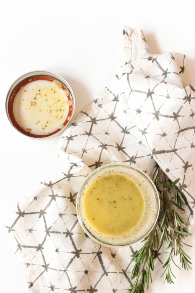 maple dijon dressing mixed in a mason jar sitting on a white kitchen towel