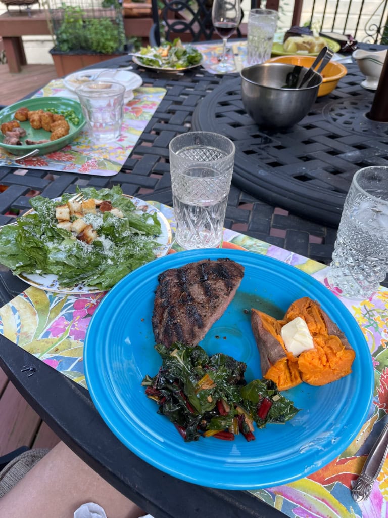 steak with sweet potato, swiss chard, and caesar salad